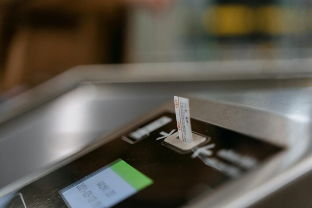 Close-up image of a subway ticket machine with a ticket inserted, highlighting public transportation convenience.